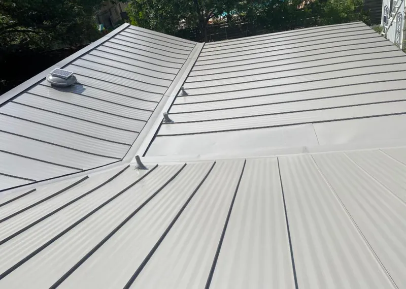 Solar attic fan installed on a metal roof for Roof Ventilation in Cherry Hills Village