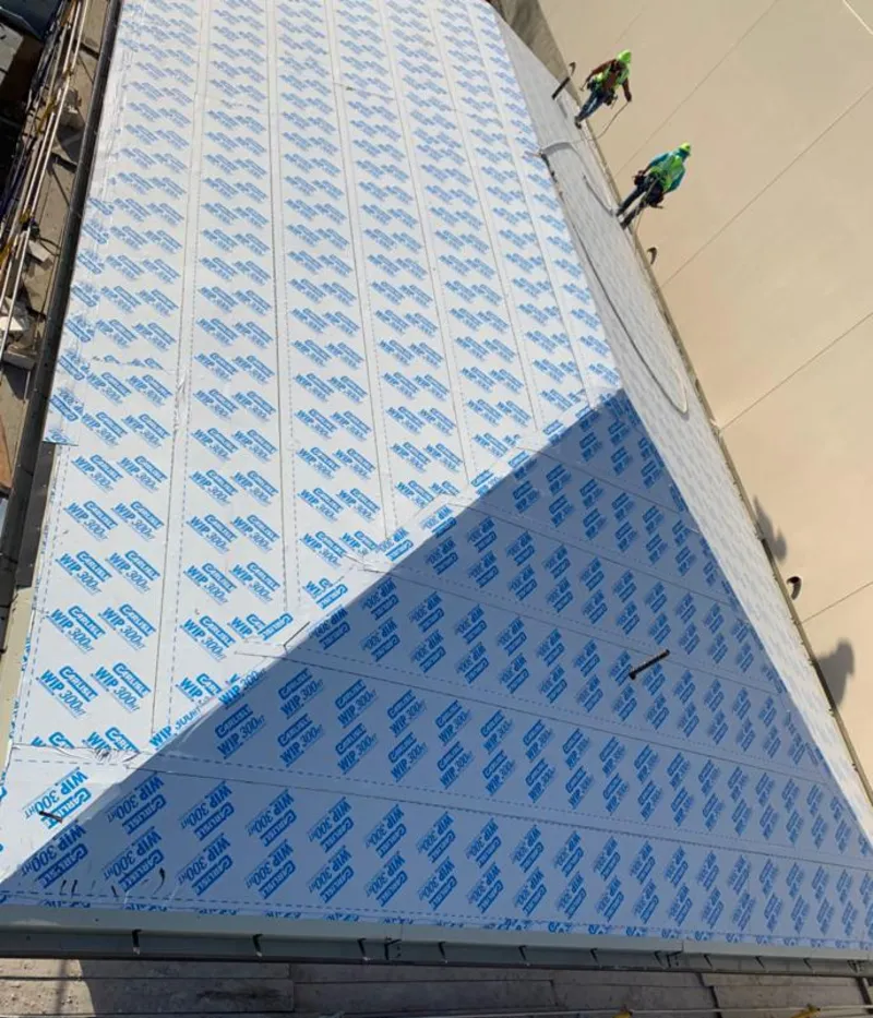 Professional roofers installing underlayment on a metal roof in Cherry Hills Village